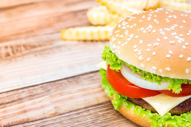 Close-up of delicious cheeseburger with lettuce and tomato