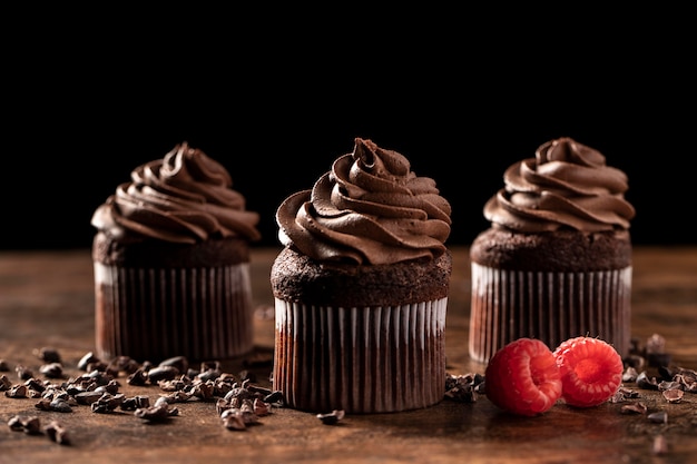 Close-up of delicious chocolate cupcakes with raspberry