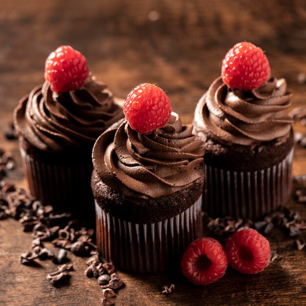 Close-up of delicious chocolate cupcakes with raspberry