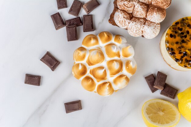 Close-up to delicious mini chocolate, lemon pie and passion fruit cake. Cook concept.