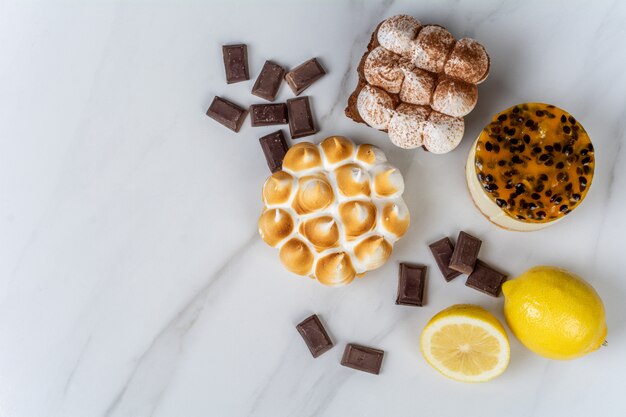 Close-up to delicious mini chocolate, lemon pie and passion fruit cake. Cook concept.