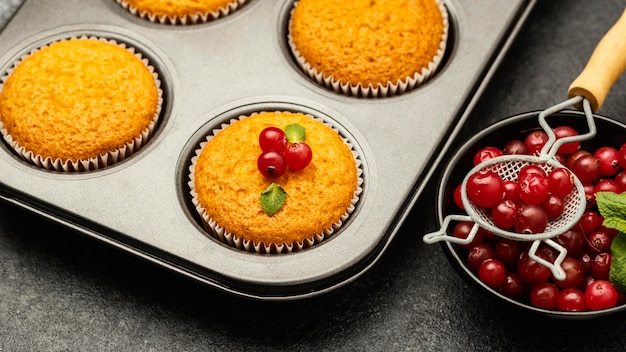 Close-up of delicious muffins with berries in pan