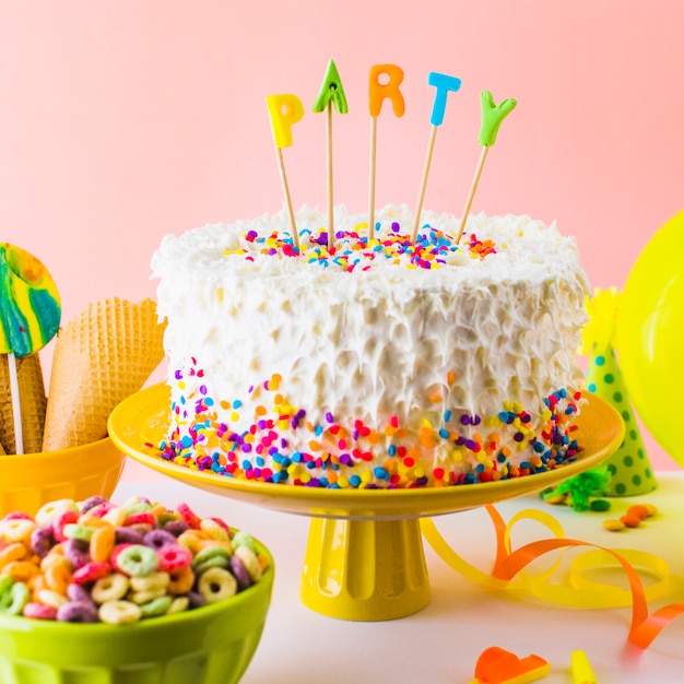 Close-up of delicious party cake with bowl of froot loop