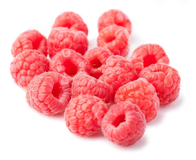 Close-up of delicious raspberries over white background