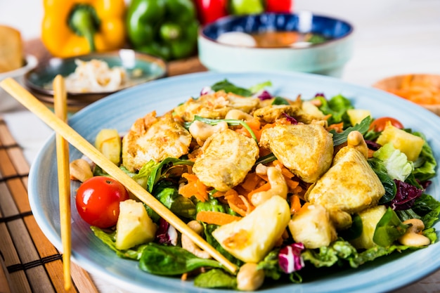 Close-up of delicious thai salad plate with chopsticks