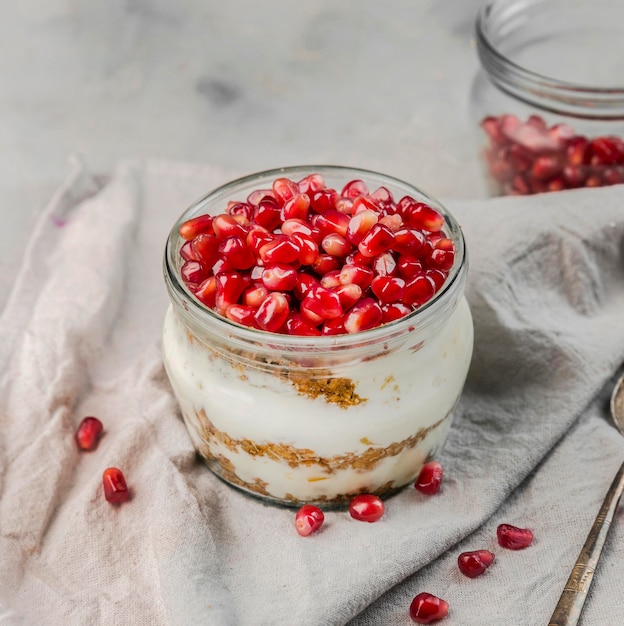 Close-up delicious yogurt with pomegranate seeds