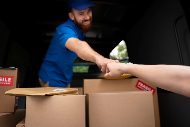 Close up delivery man fist bump