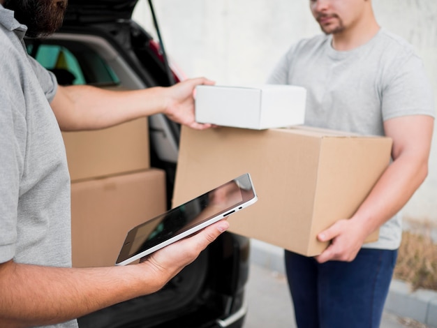 Close-up delivery man with boxes