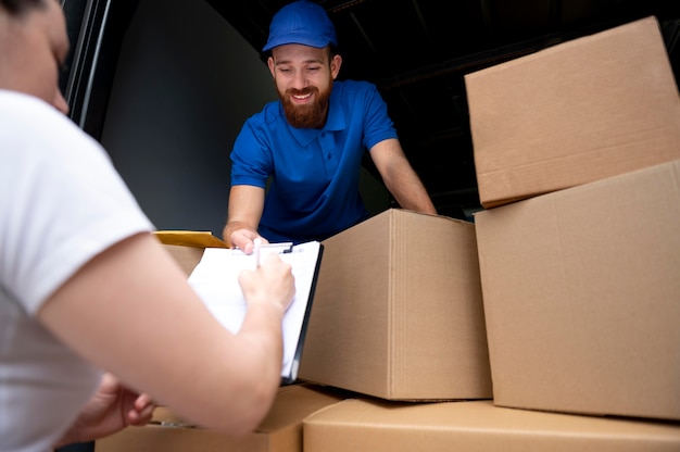 Close up delivery man with boxes