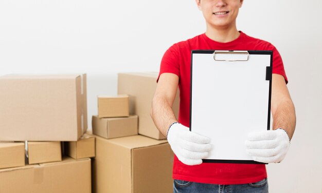 Close-up delivery man with clipboard