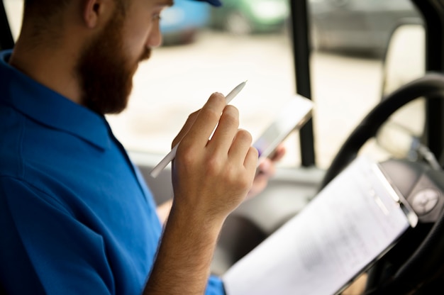 Close up delivery man with document