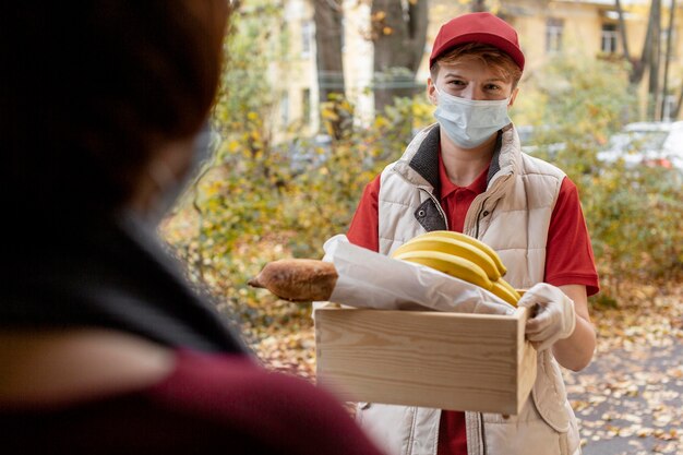 Close-up delivery man with food crate