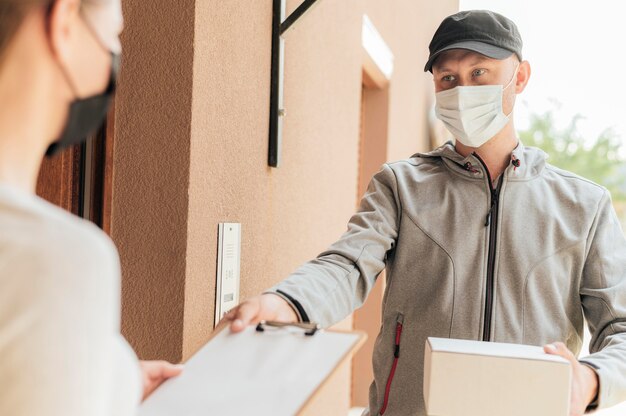 Close-up delivery man with package