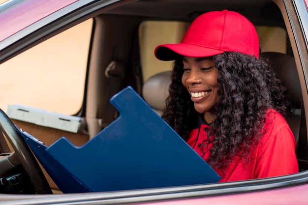 Close up on delivery person looking over papers