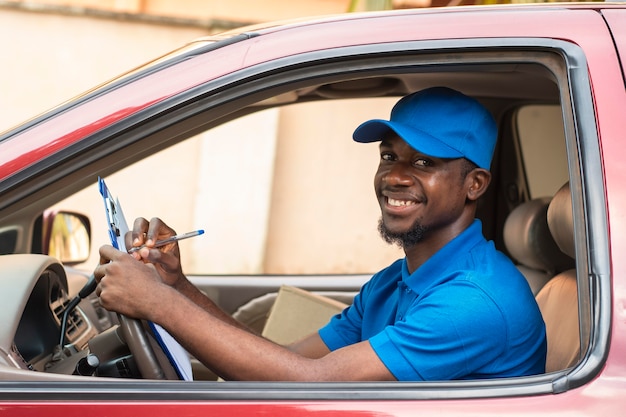 Close up on delivery person with documents in car