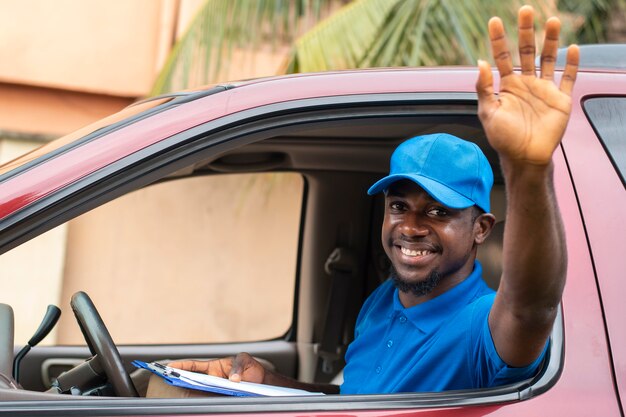 Close up on delivery person with documents in car