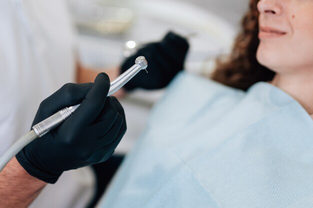 Close-up of dental instrument with surgical gloves