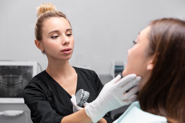 Close up dentist checking patient