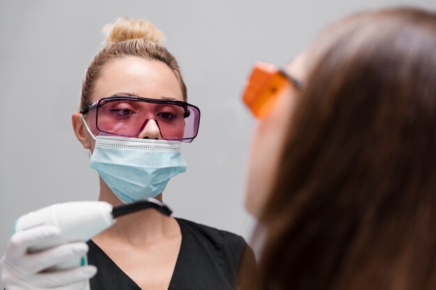 Close up dentist with face mask and goggles