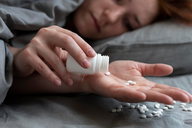 Close up depressed woman with pills
