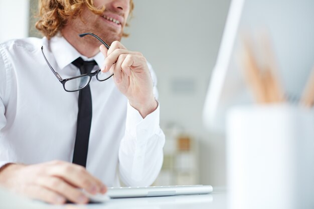 Close-up of designer holding his glasses