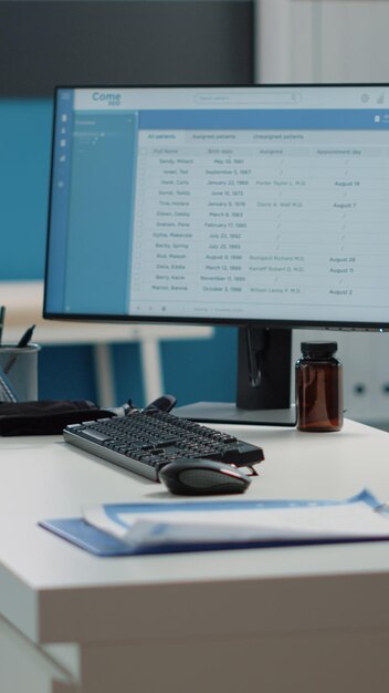 Close up of desk with computer and medical instruments in doctors office. Empty cabinet with equipment and tools used for examination and checkup visit. Nobody in space for healthcare