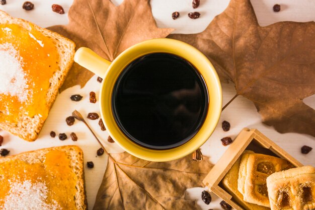 Close-up desserts and leaves near coffee