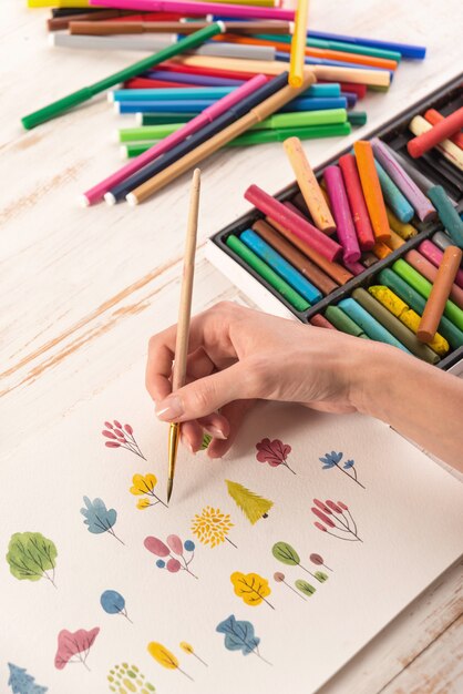 Close up of different colorful flowers nature design painted with brush and watercolors on paper