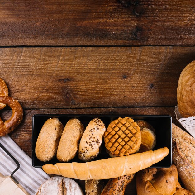 Close-up of different fresh baked bread on wooden table