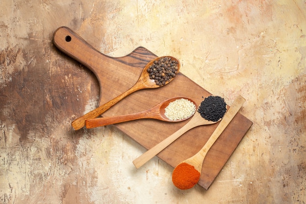 Close up of different spices lined in wooden spoons