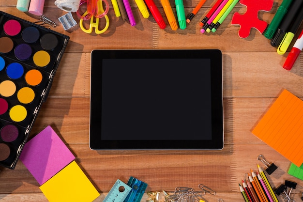 Close-up of digital tablet with various stationery