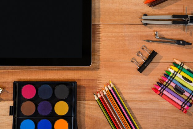 Close-up of digital tablet with various stationery