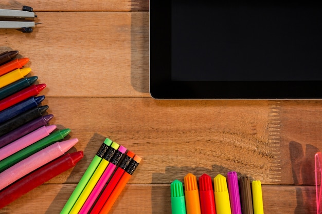 Close-up of digital tablet with various stationery