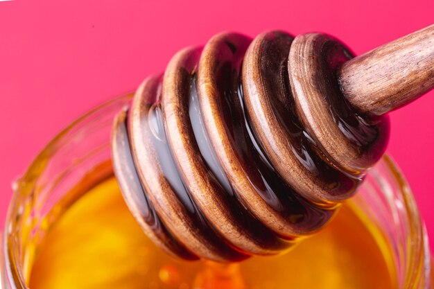 Close up dipper with honey jar