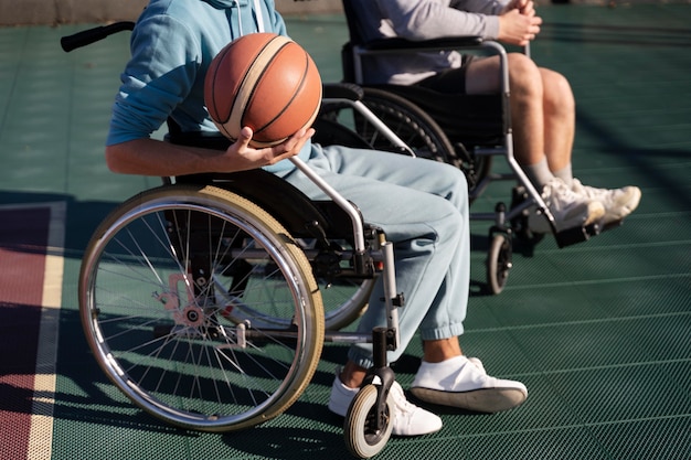Close up disabled friends with ball