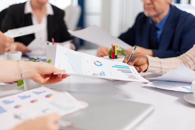 Close up of diverse startup company colleagues meeting in professional workplace