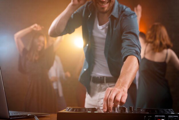 close up dj working at club