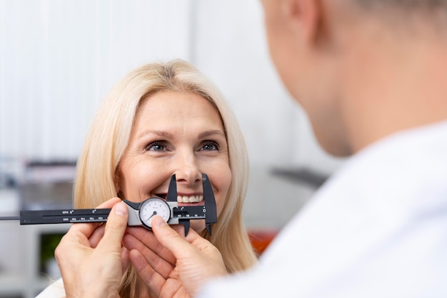 Close up doctor checking happy patient