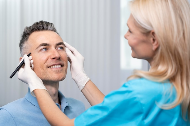 Free photo close up doctor checking smiley patient