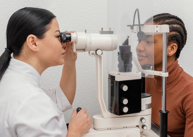 Close up doctor checking woman eyes