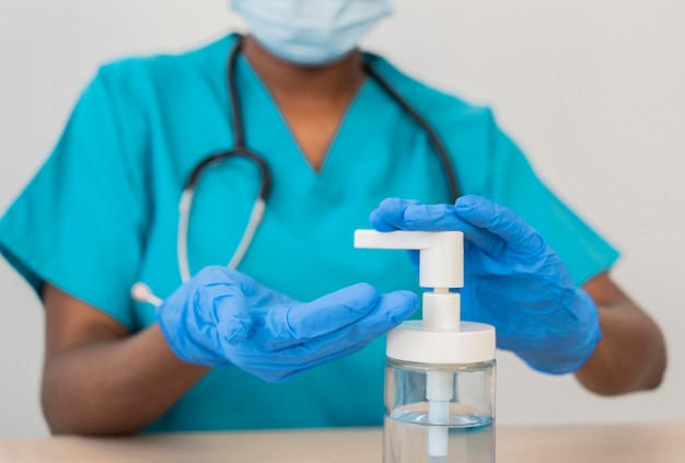 Close-up doctor disinfecting hands