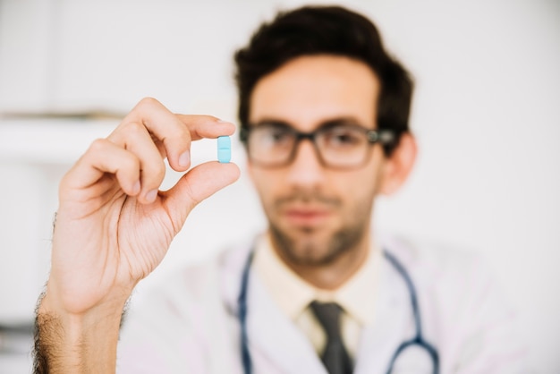 Foto gratuita primo piano di una pillola della holding della mano del medico