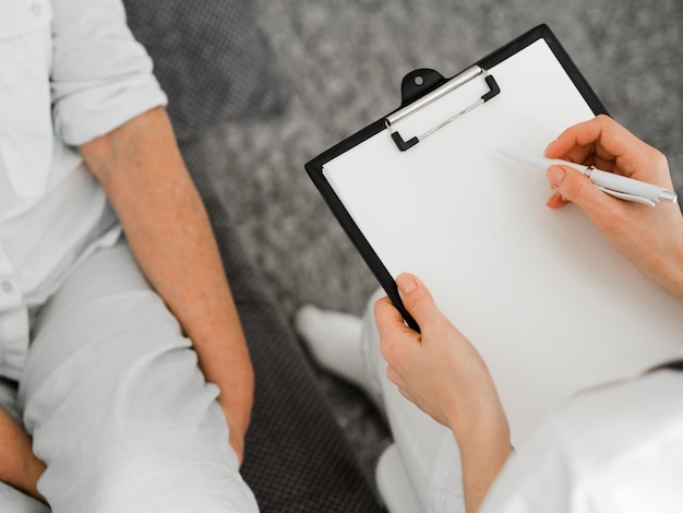 Close-up doctor holding clipboard