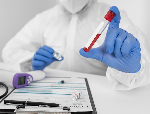 Close-up doctor holding covid sample