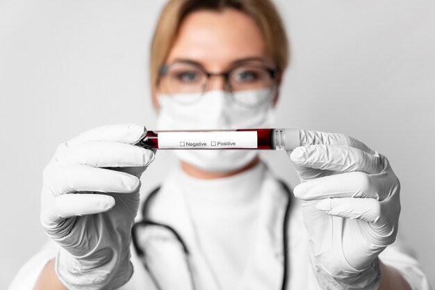 Close-up doctor holding medical virus sample