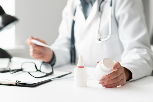 Close-up doctor holding medicine