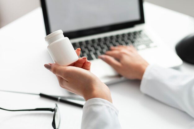 Close-up doctor holding medicine