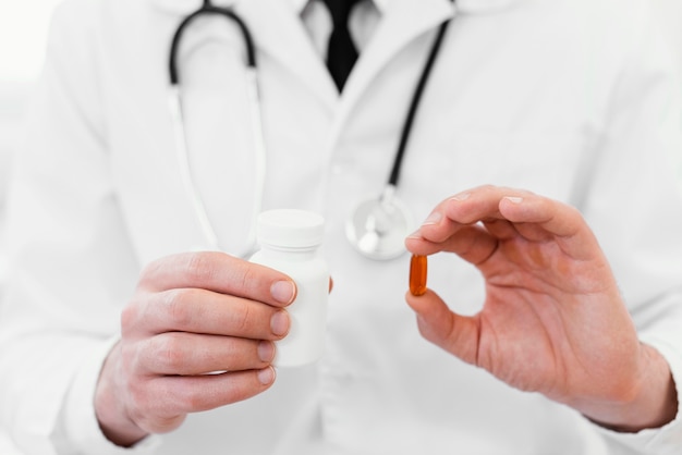 Close-up doctor holding medicine