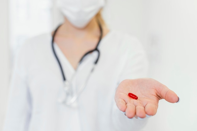 Close-up doctor holding pill