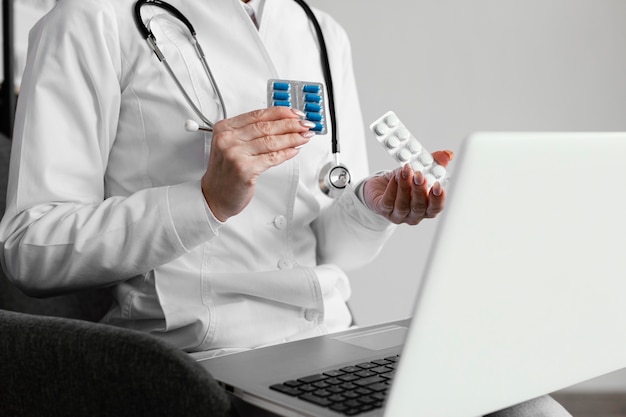 Close-up doctor holding pills